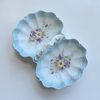 Her Good Eye antique divided serving dish with purple and yellow pansies, gold trim, and scalloped blue edges.