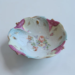 Her Good Eye antique porcelain serving bowl with floral motif, pastel blue, creamy white, magenta, and gold accents.