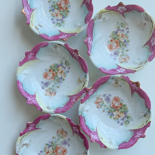 Her Good Eye antique porcelain serving bowl with floral motif, scalloped rim, pastel blue and magenta glaze, and gold detailing.