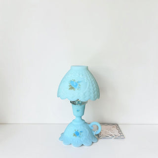 Her Good Eye vintage blue satin glass table lamp with hand-painted floral details and a scalloped silhouette.