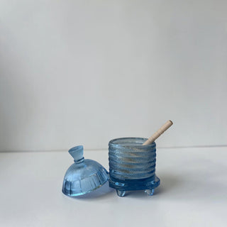 Her Good Eye blue glass honey pot with dipper, ribbed beehive design, on four feet.