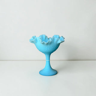 Her Good Eye vintage sky blue milk glass pedestal bowl with a ruffled scalloped rim and embossed floral pattern.