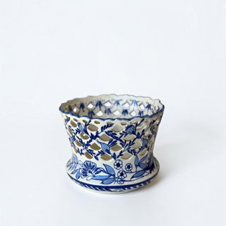 Her Good Eye blue and white glazed ceramic cachepot with intricate hand-painted floral motifs and lattice-work rim.
