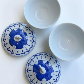Her Good Eye blue and white floral ceramic bowls with lids, set of 2. White interior, blue Chinoiserie pattern on lids.