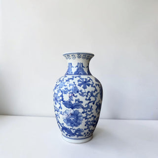 Her Good Eye blue and white porcelain vase with intricate floral motifs. Traditional cobalt blue floral patterns.