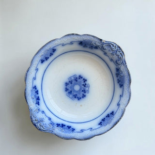 Her Good Eye blue and white floral ceramic serving bowl with scalloped edge and embossed rim detail.