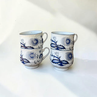 Her Good Eye blue and white floral ceramic teacups with scalloped edges and black trim. Set of 4.