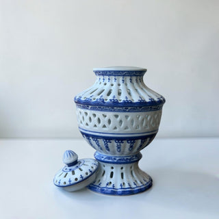 Her Good Eye blue and white porcelain lattice urn with lid, featuring intricate cutwork and floral motifs.