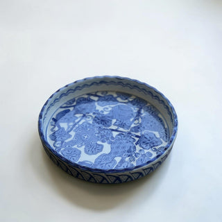 Her Good Eye blue and white ceramic serving dish with scalloped edge and floral motifs. Decorative ceramic dish.