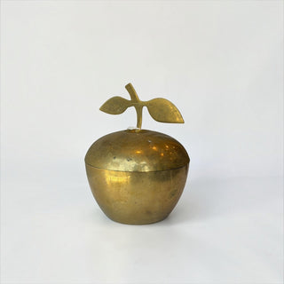 Her Good Eye vintage brass apple-shaped trinket box with a leaf stem handle and a warm golden patina finish.