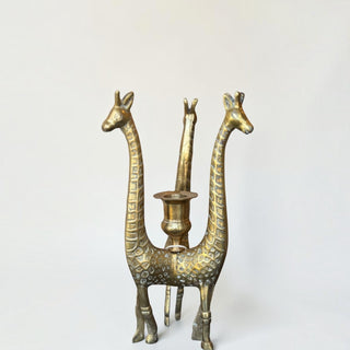 Her Good Eye vintage brass giraffe figural candlestick holder with three giraffes supporting a central candle cup.