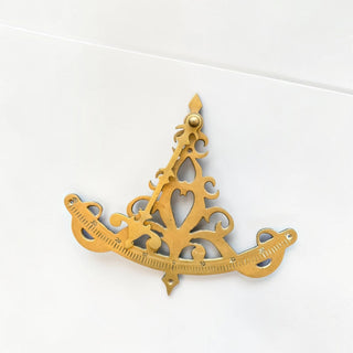 Her Good Eye decorative brass nautical sextant wall hanging with intricate scrollwork and etched degree markings.