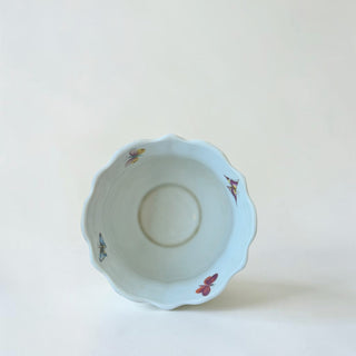Her Good Eye porcelain planter pot with scalloped rim, featuring colorful butterflies and a gold trim. Ideal for plants.