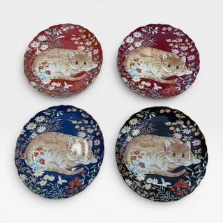 Her Good Eye set of four decorative ceramic plates featuring a ginger cat resting among floral patterns in four colors