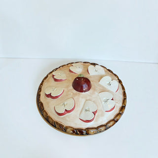 Her Good Eye ceramic apple pie serving dish with a whimsical lid featuring hand-painted apple slices and glossy finish.