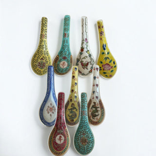 Her Good Eye set of nine artisanal ceramic soup spoons with vibrant hand-painted Asian motifs and floral patterns.