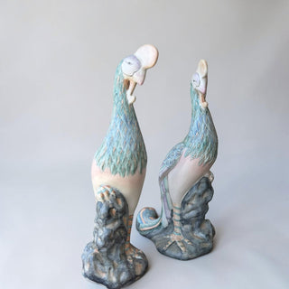Her Good Eye set of two whimsical ceramic bird sculptures in pastel blue, green, and pink with textured feathers and rocky bases.