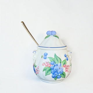 Her Good Eye ceramic sugar bowl with hand-painted blueberry motif, scalloped edges, lid, and silver-toned spoon.
