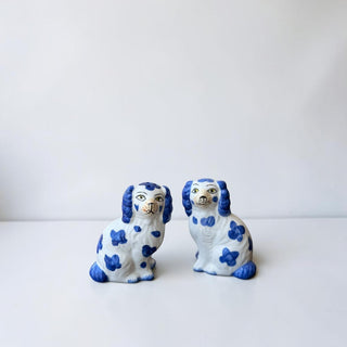 Her Good Eye pair of white ceramic dog figurines with blue Delftware-style patterns and floppy ears.
