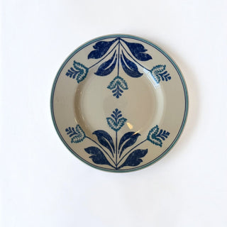 Her Good Eye ceramic dinner plate with cream base and intricate deep blue symmetrical floral botanical motif