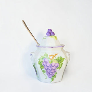 Her Good Eye hand-painted white ceramic sugar bowl with a purple grape motif, lid, and silver-toned serving spoon.