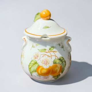 Her Good Eye decorative ceramic jam jar with peach and blossom design, featuring orange trim and handles.