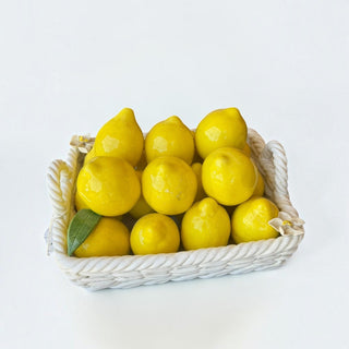 Her Good Eye ceramic lemon fruit basket with high-gloss yellow lemons in a white woven-style decorative bowl