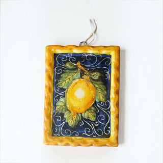 Her Good Eye hand-painted ceramic wall plaque featuring a yellow lemon on a navy blue background with gold border.