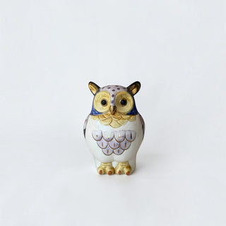 Her Good Eye ceramic owl figurine in lavender, blue, and cream with gold-leaf accents and a glossy finish.
