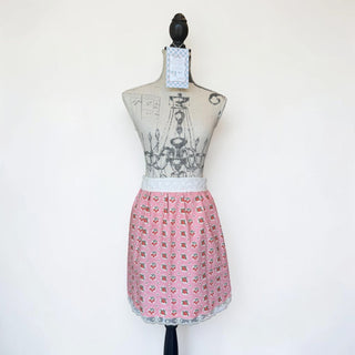 Her Good Eye pink gingham half apron with cherry and strawberry print, white eyelet lace trim and waistband.