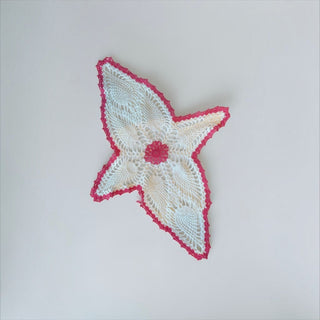 Her Good Eye handmade white crochet doily with a vibrant pink star-shaped border and intricate lace detailing.