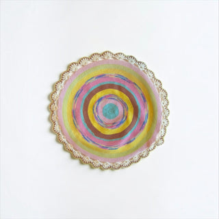Her Good Eye handmade circular crochet table mat with vibrant concentric rings and a scalloped cream lace border.