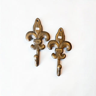 Her Good Eye set of two antiqued bronze cast iron Fleur-de-Lis wall hooks with a vintage French-inspired design.