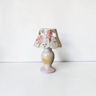 Her Good Eye vintage-style ceramic table lamp with hand-painted pink and blue floral motifs and iridescent glaze.