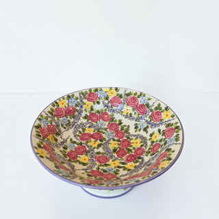 Her Good Eye hand-painted ceramic pedestal bowl with vibrant pink rose and yellow floral pattern and purple rim