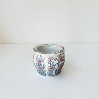 Her Good Eye hand-painted ceramic planter with a delicate pink, yellow, and green floral motif on a white glazed finish.