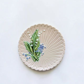 Her Good Eye ceramic serving plate with ribbed texture and hand-painted lily of the valley floral motif.