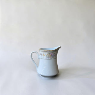 Her Good Eye floral patterned porcelain creamer pitcher with gold rim and pink, yellow, lavender roses.