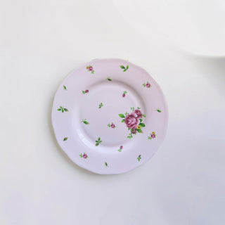 Her Good Eye lavender porcelain dinner plate with pink roses and green leaves, scalloped gold trim.