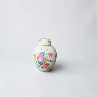 Her Good Eye floral ginger jar with lid, porcelain with pink, blue, and yellow flowers on ivory background.