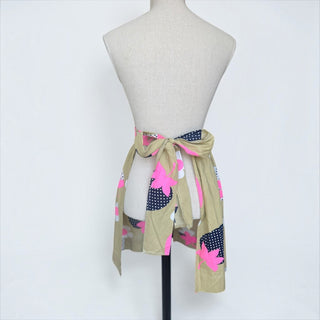 Her Good Eye vintage-inspired half apron in khaki with pink floral and navy polka-dot print tied on a mannequin.