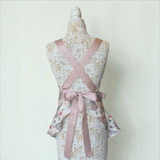 Her Good Eye floral paisley kitchen apron with dusty rose satin ribbon ties and ruffled hem on a mannequin back view