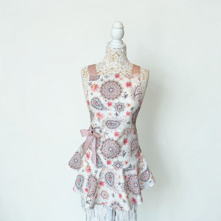Her Good Eye floral paisley kitchen apron with dusty rose ribbon ties and ruffled hem on a mannequin