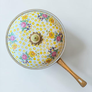 Her Good Eye floral polka dot covered skillet pan with yellow polka dots and colorful flowers. Features a decorative knob on the lid.