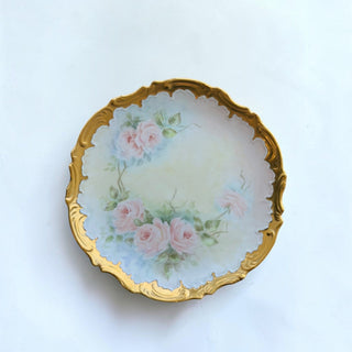 Her Good Eye vintage porcelain decorative plate with hand-painted pink roses and a scalloped gold-trimmed edge.