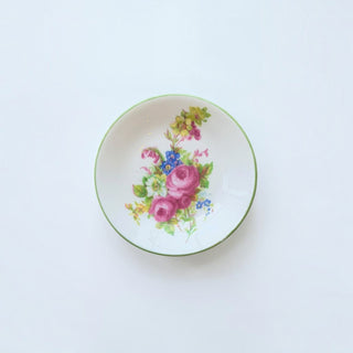 Her Good Eye vintage porcelain trinket dish with hand-painted pink and blue floral bouquet and green rim.
