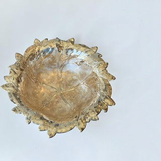 Her Good Eye decorative glass serving bowl with a metallic gold finish and detailed leaf-motif rim.