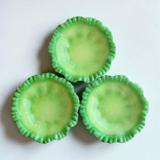 Her Good Eye decorative ceramic serving bowl with ruffled edge in glossy green. Perfect for trinkets or candy.