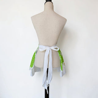 Her Good Eye green cotton half apron with white daisy print, white lace trim, and grey linen-like contrast layer.