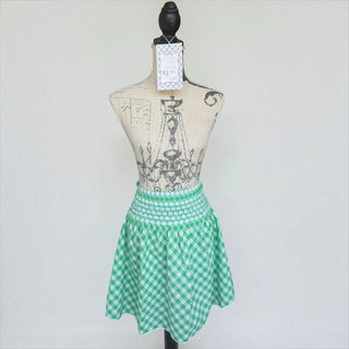 Her Good Eye green and white gingham waist apron with smocked waistband and delicate white lace hem on a mannequin.